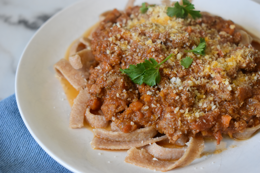 A plate with whole wheat fettucine topped with hidden liver beef bolognese sauce