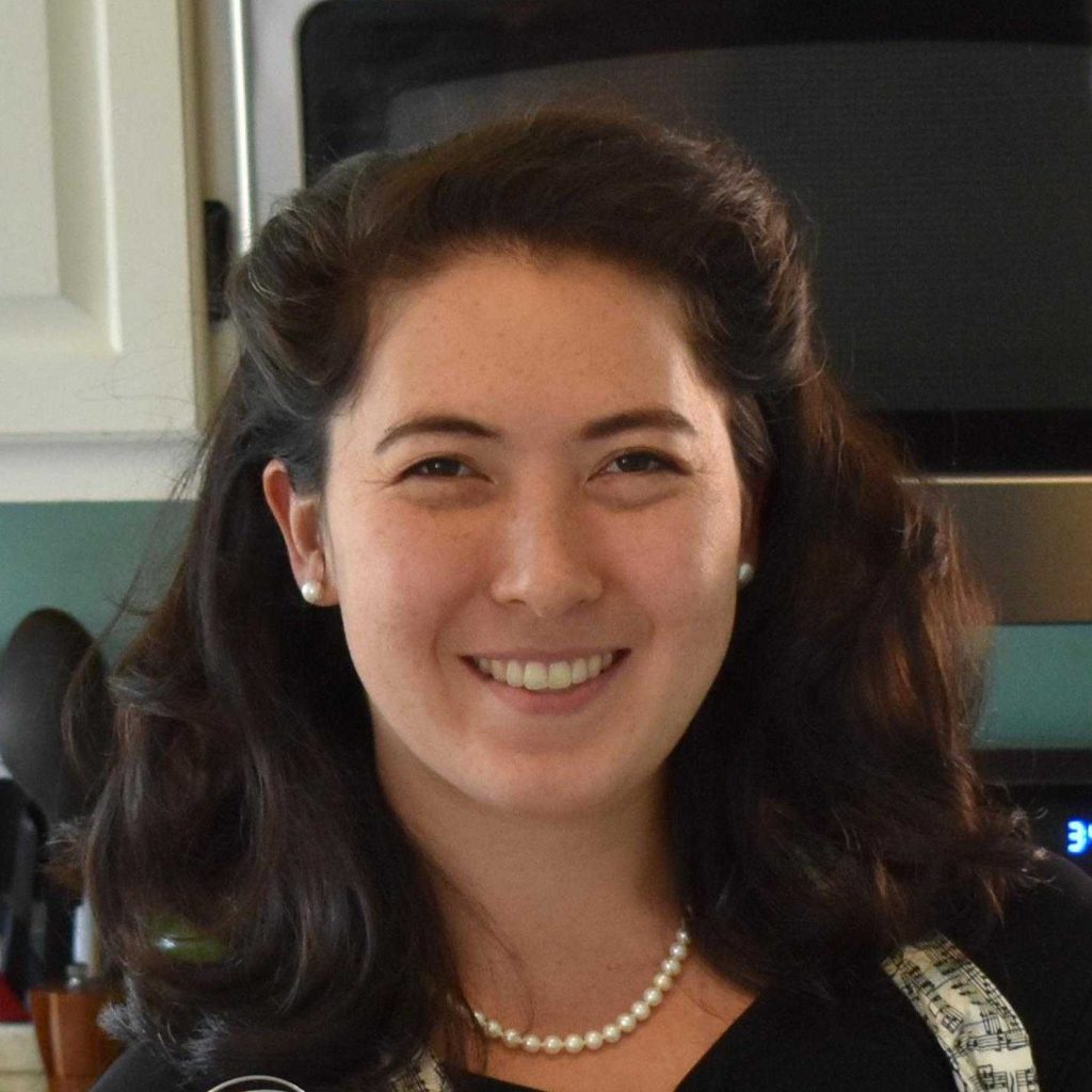 Smiling woman wearing an apron in a kitchen